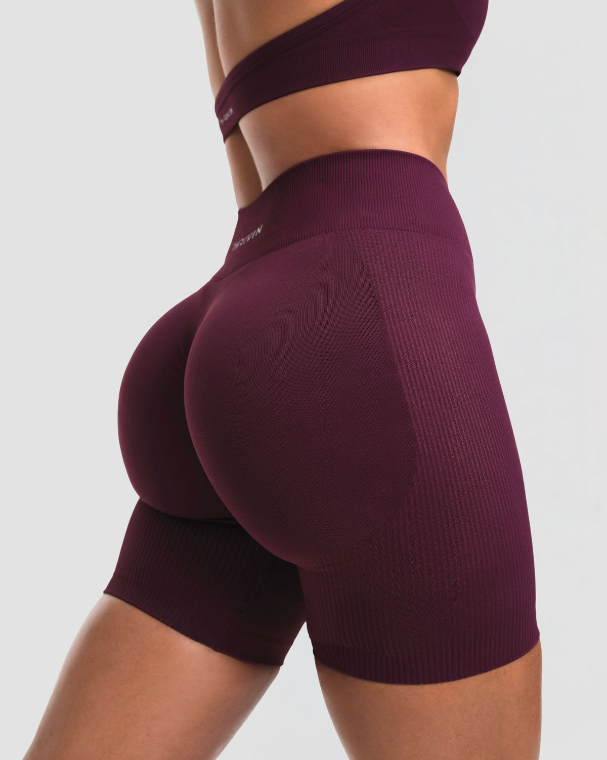 Elevate Sculpting Mid Waist Scrunch Shorts in Winter Plum Red, back close-up of sculpted seat and ribbed sculpting knit