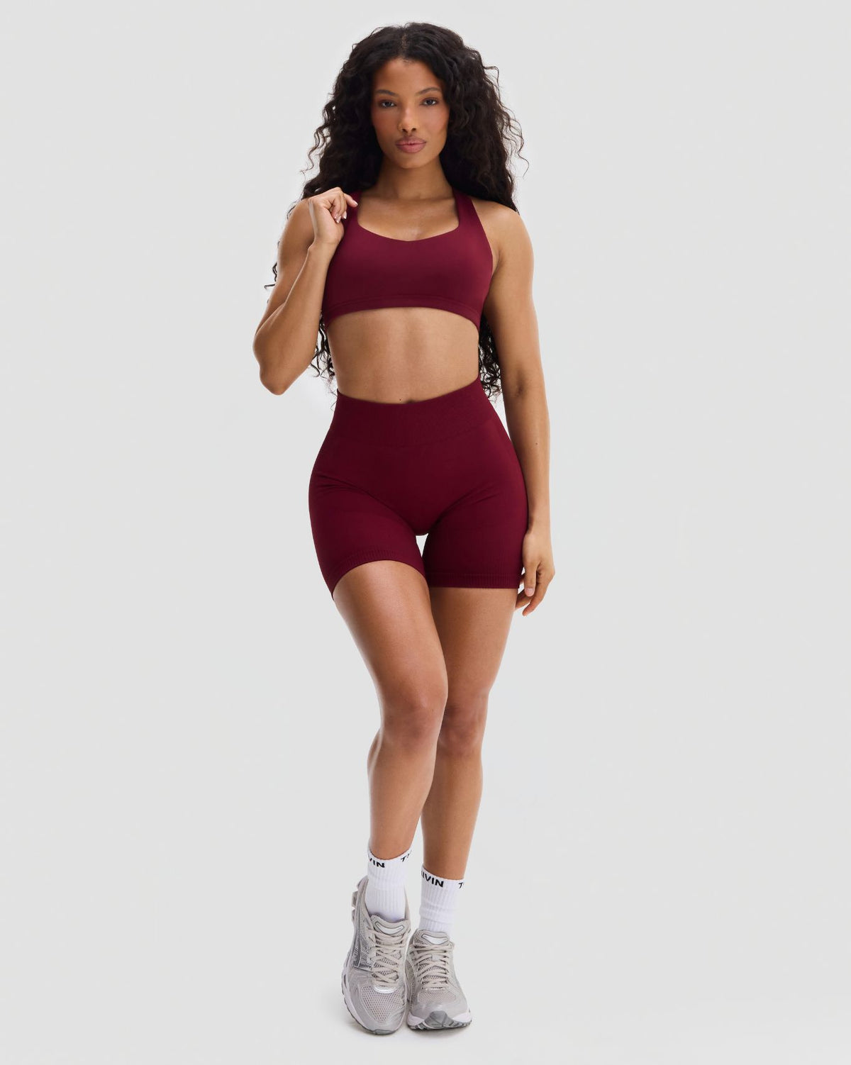Elevate Sculpting Medium Impact Multiway Bra in Fine Wine Red, full-length front view with matching shorts