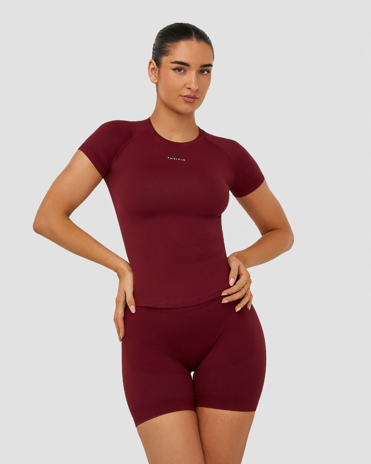 Elevate Compression T-Shirt in Fine Wine Red, front view of the gym T-shirt with crew neck, raglan sleeves and Thrivin logo