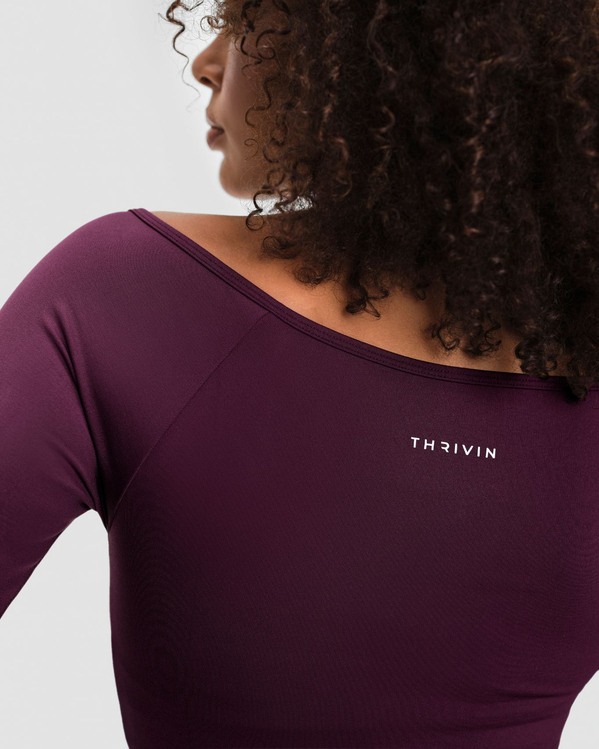Elevate Sculpting Seamless V-Neck Top in Winter Plum Red, back close-up of wide neckline and THRIVIN logo