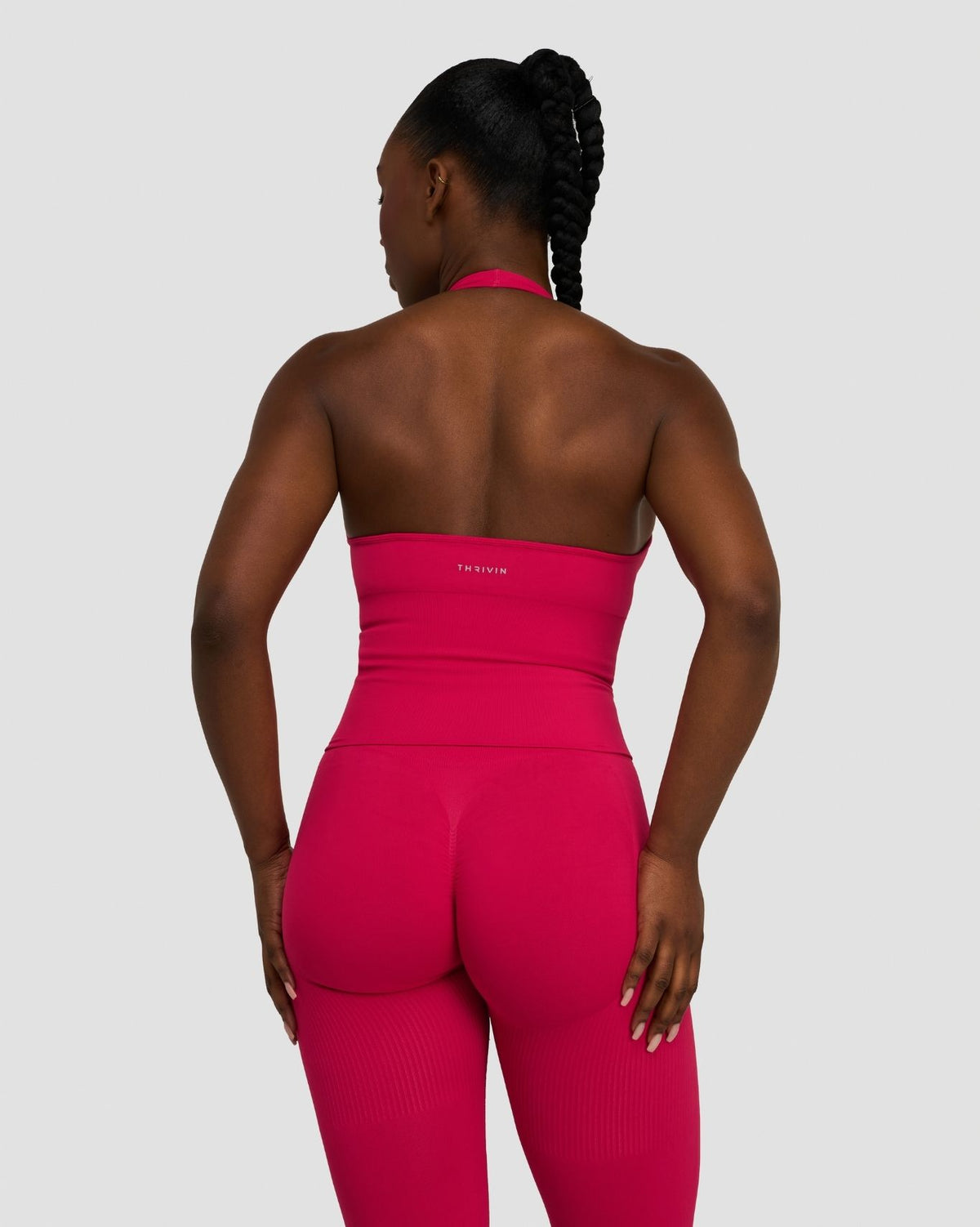 Elevate Sculpting Seamless Halterneck Top in Strawberry, back view of open back and THRIVIN logo band