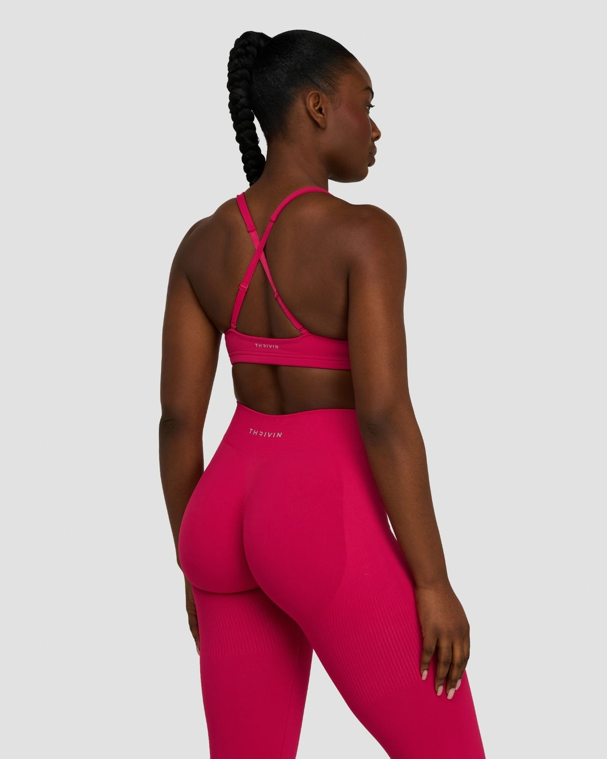 Elevate Sculpting Medium Impact Multiway Bra in Strawberry, back view showing crossed straps and leggings