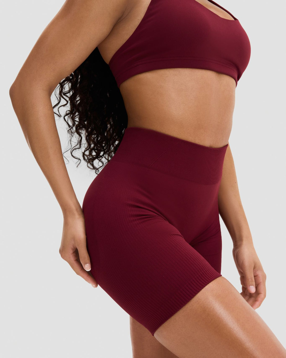 Elevate Sculpting Mid Waist Scrunch Shorts in Fine Wine Red, close-up of the wide waistband and fine ribbed sculpting knit