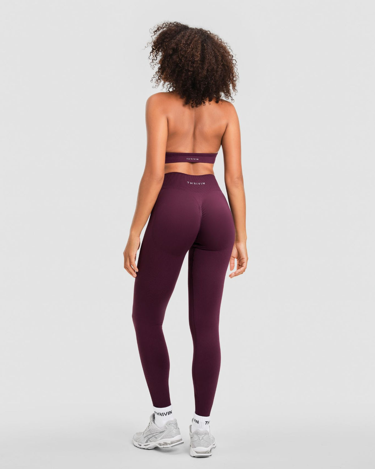 Elevate Sculpting Mid Waist Scrunch Leggings in Winter Plum Red, back view with Thrivin logo waistband and scrunch seam