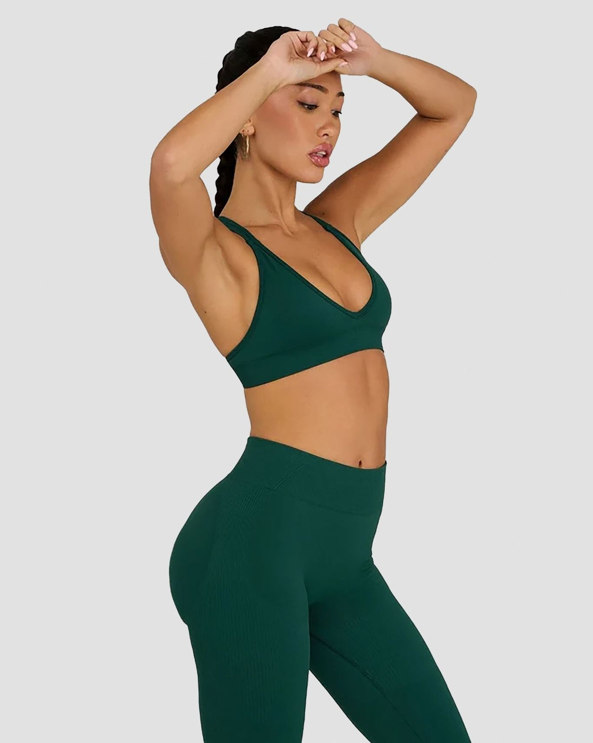 Elevate Sculpting Seamless High Apex Bra in Pine Green, three-quarter front view of V-neckline with arms raised