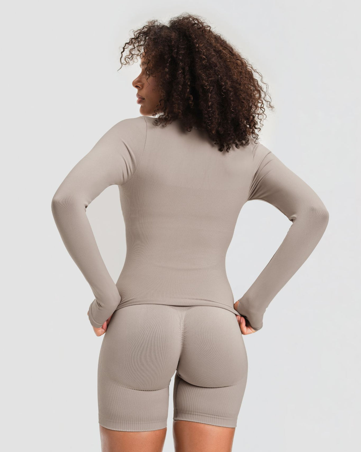 Elevate Compression Long Sleeve Jacket in Latte Grey, back view with thumbholes and fitted waist