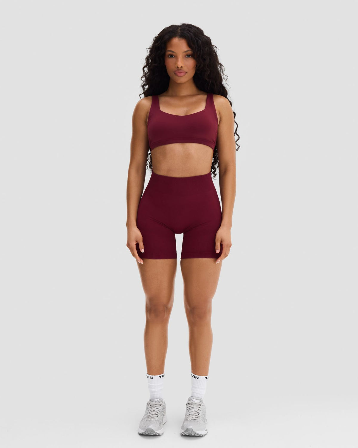 Elevate Sculpting Mid Waist Scrunch Shorts in Fine Wine Red, full-length front view of the gym shorts with mid waistband