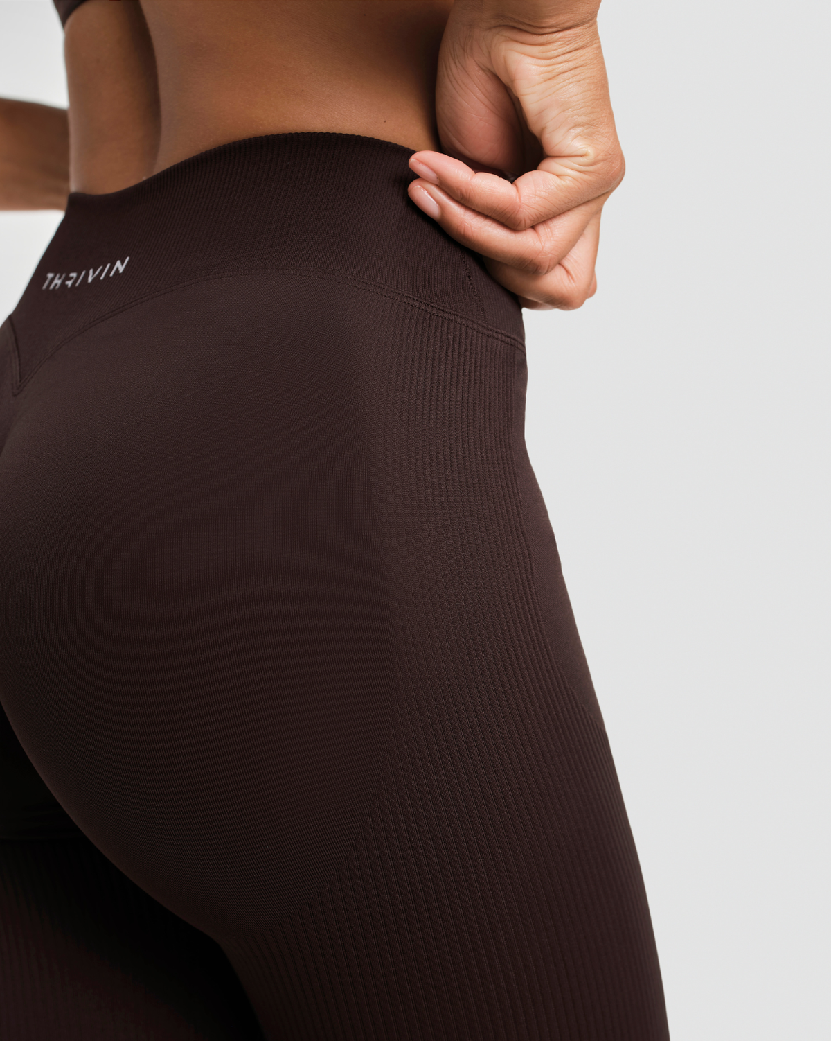 Elevate Sculpting Mid V-Waist Flare Leggings in Coffee Brown, back close-up of ribbed squat-proof knit and THRIVIN logo