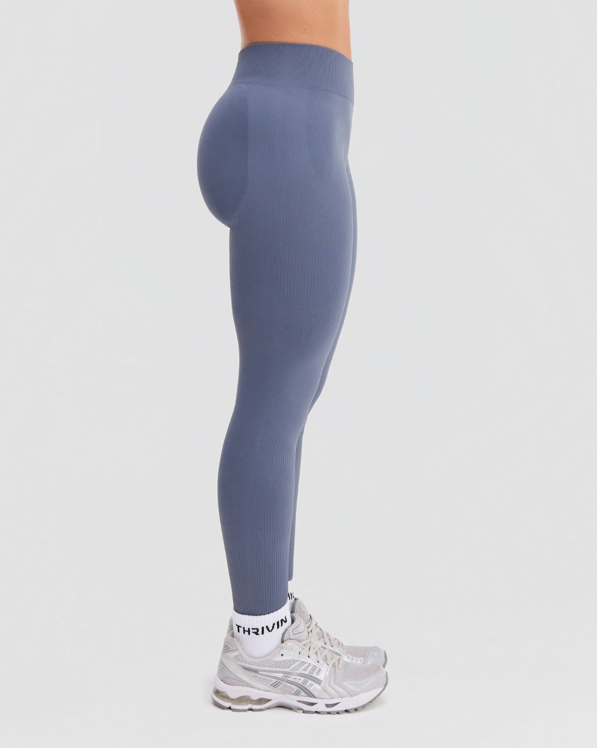 Elevate Sculpting Mid Waist Scrunch Leggings in Steel Blue, side view from waist to ankle with mid waist rise and ribbed knit