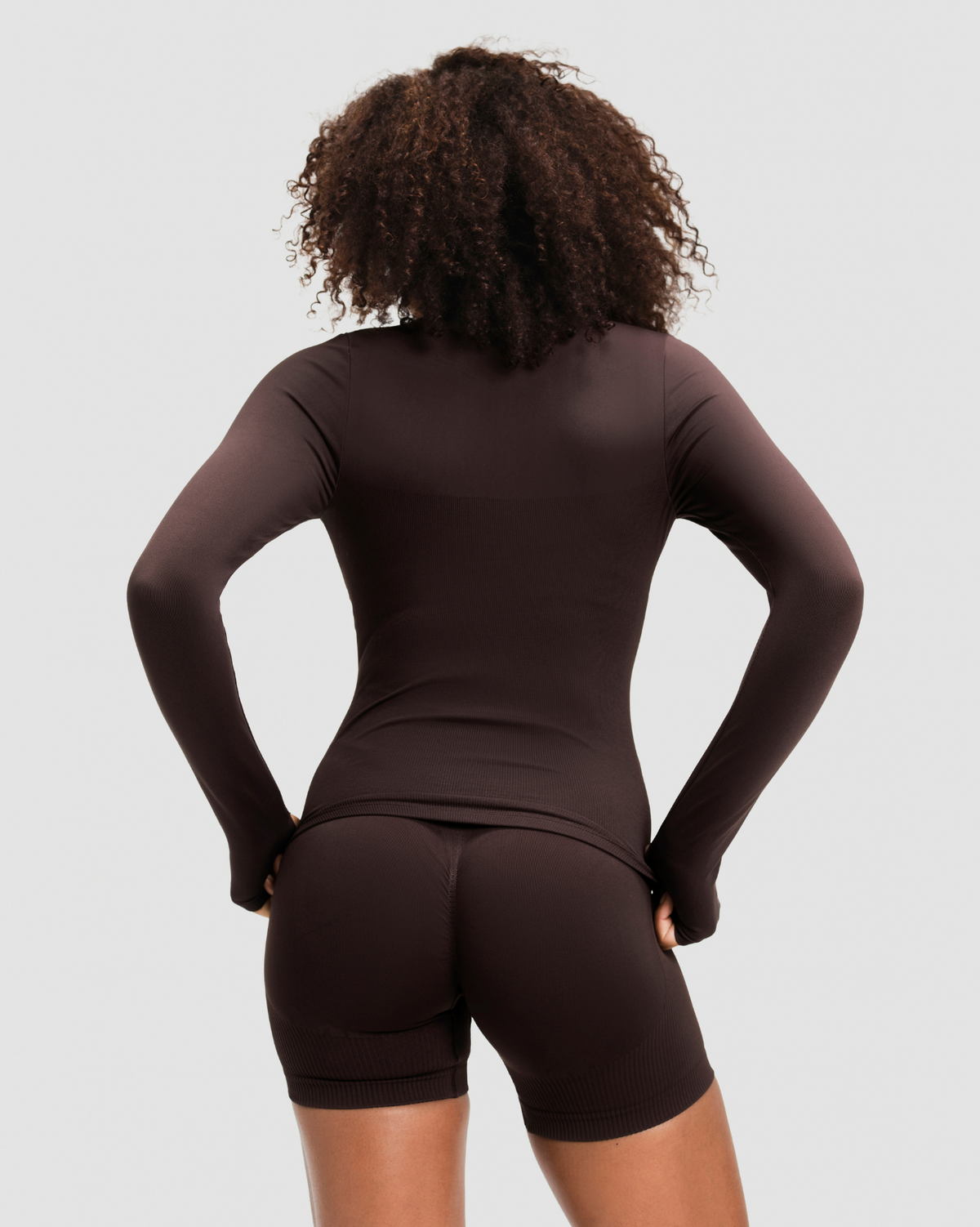 Elevate Compression Long Sleeve Jacket in Coffee Brown, back view of the long sleeves and thumbhole cuffs