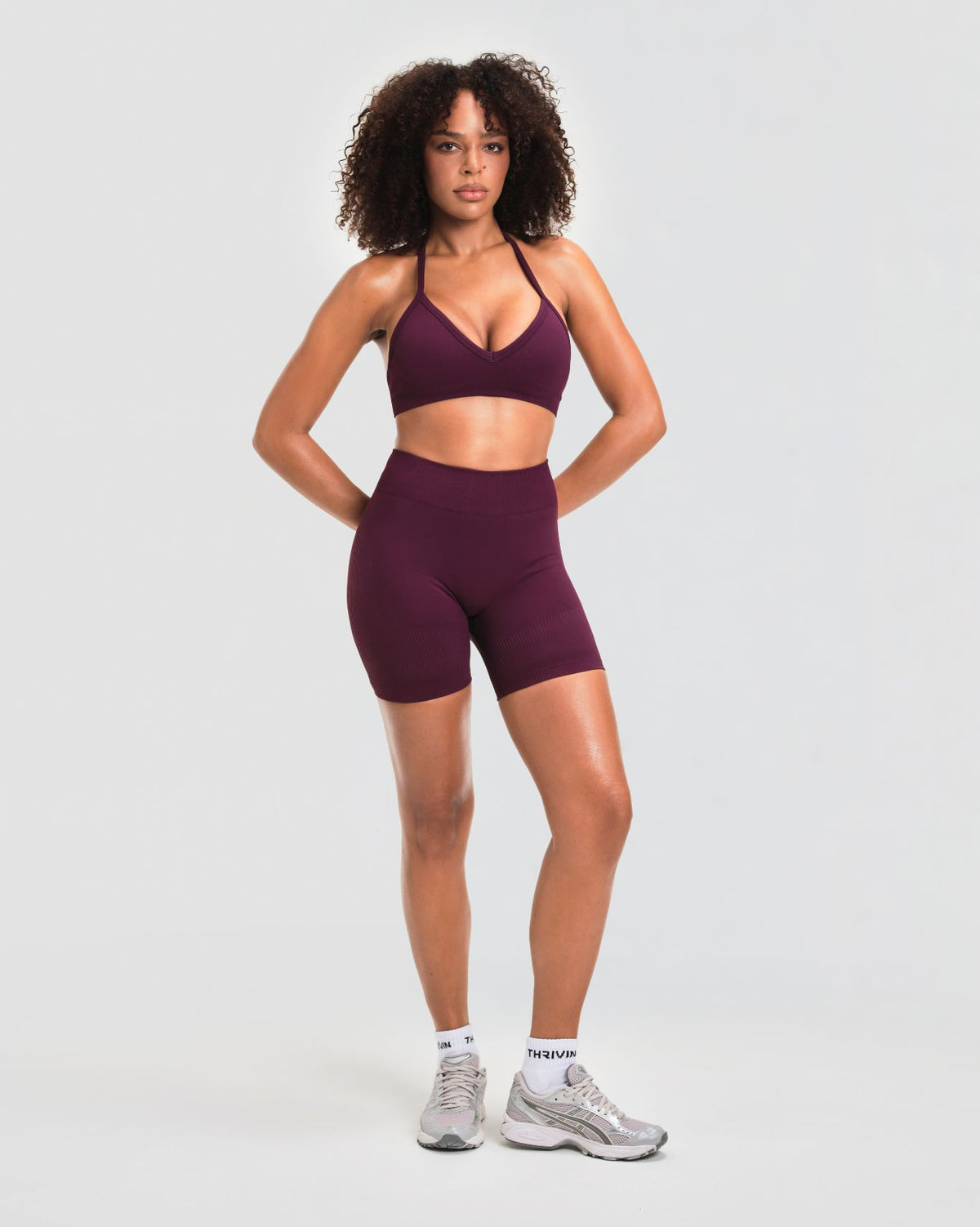 Elevate Sculpting Mid Waist Scrunch Shorts in Winter Plum Red, full-length front view of mid waist rise and regular inseam
