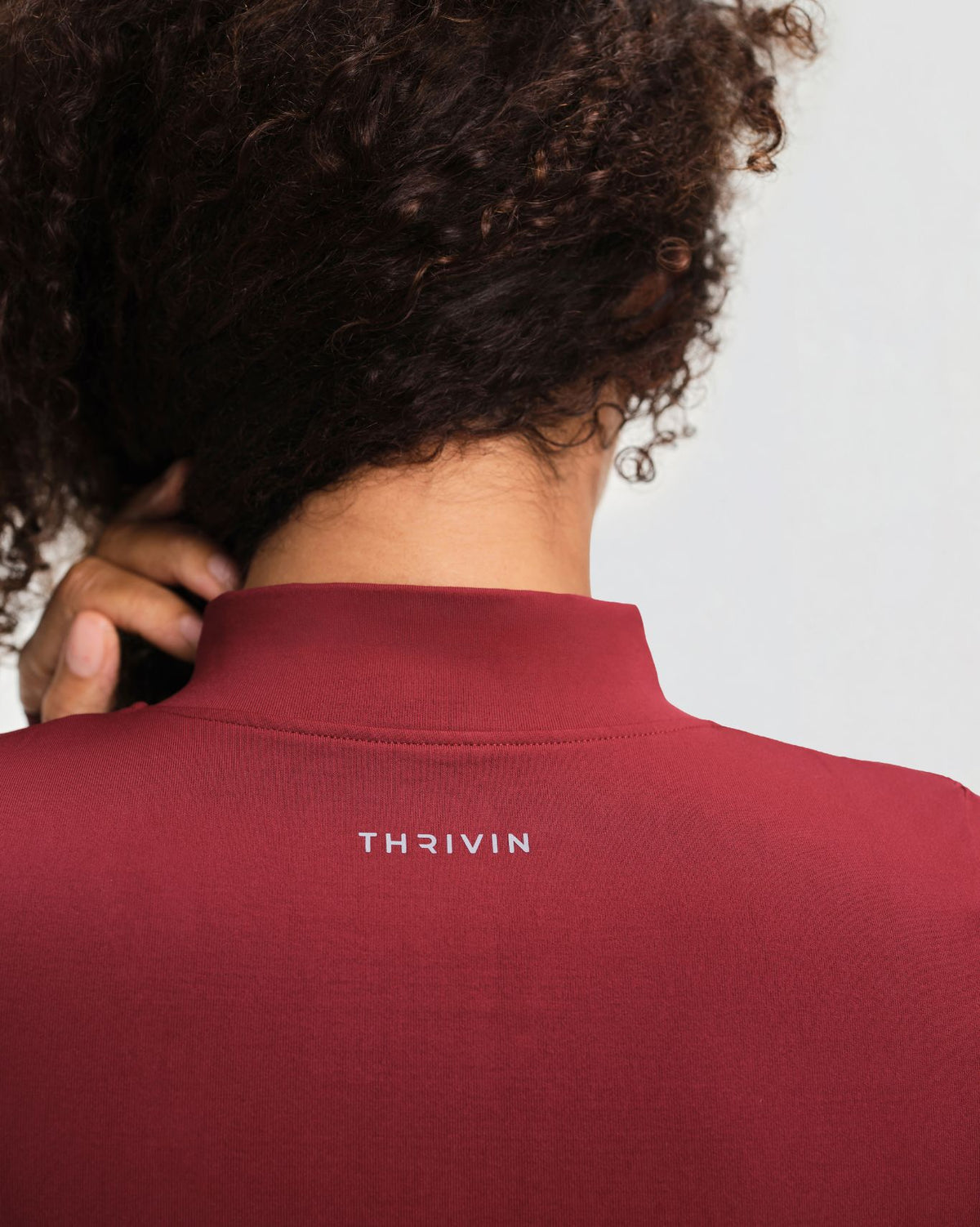 Elevate Compression Long Sleeve Jacket in Fine Wine Red, back close-up of stand collar and THRIVIN logo