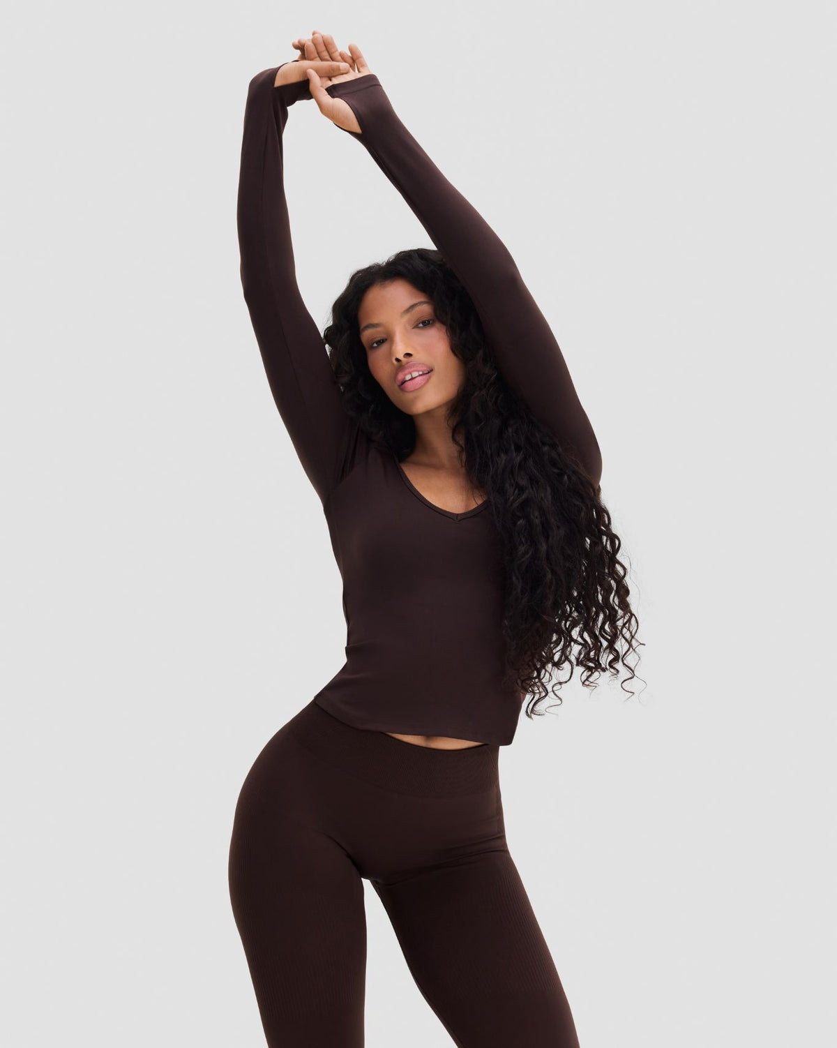 Elevate Sculpting Seamless V-Neck Top in Coffee Brown, front view with arms stretched overhead