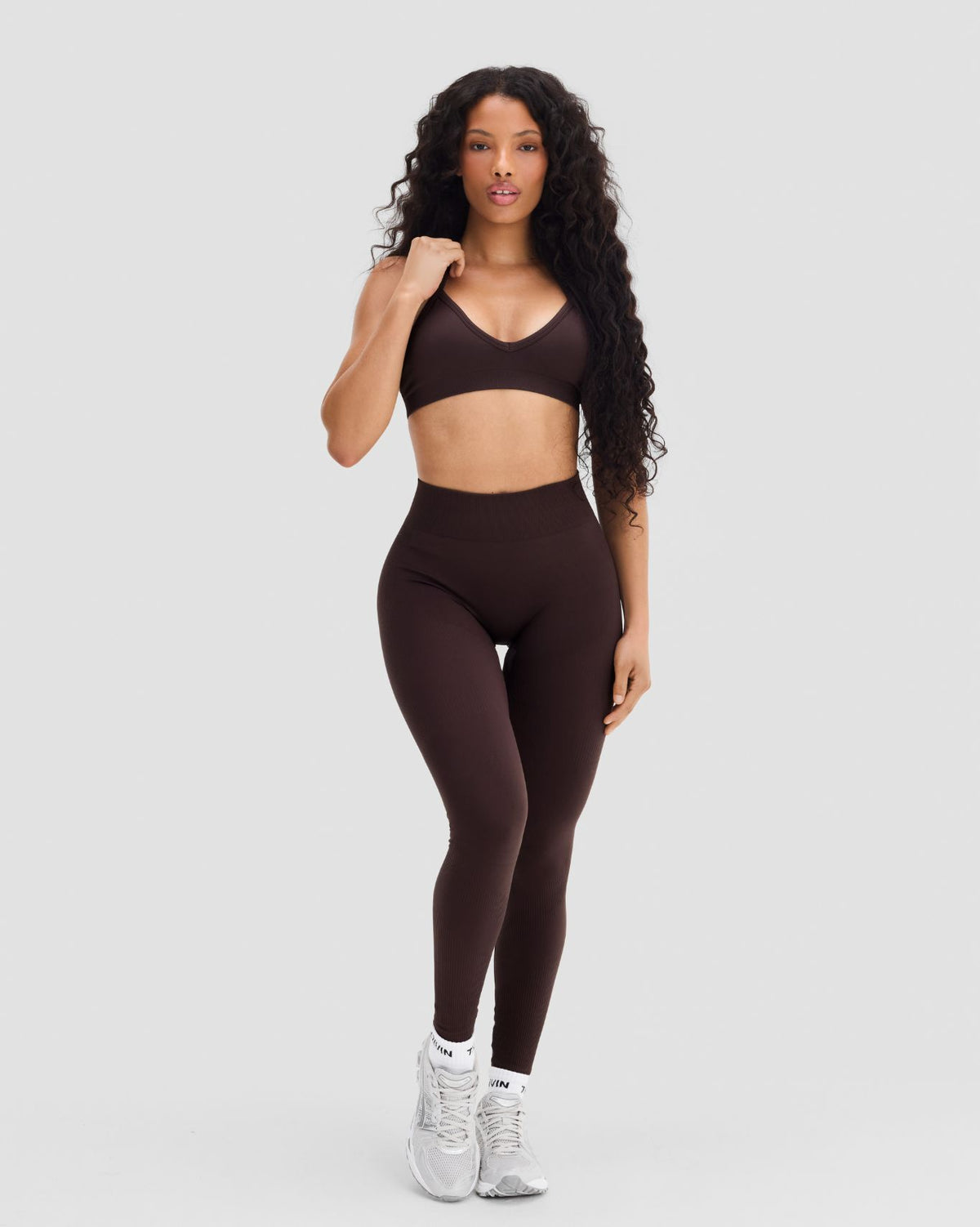 Elevate Sculpting Seamless Adjustable Halter Bra in Coffee Brown, full-length front view styled with leggings