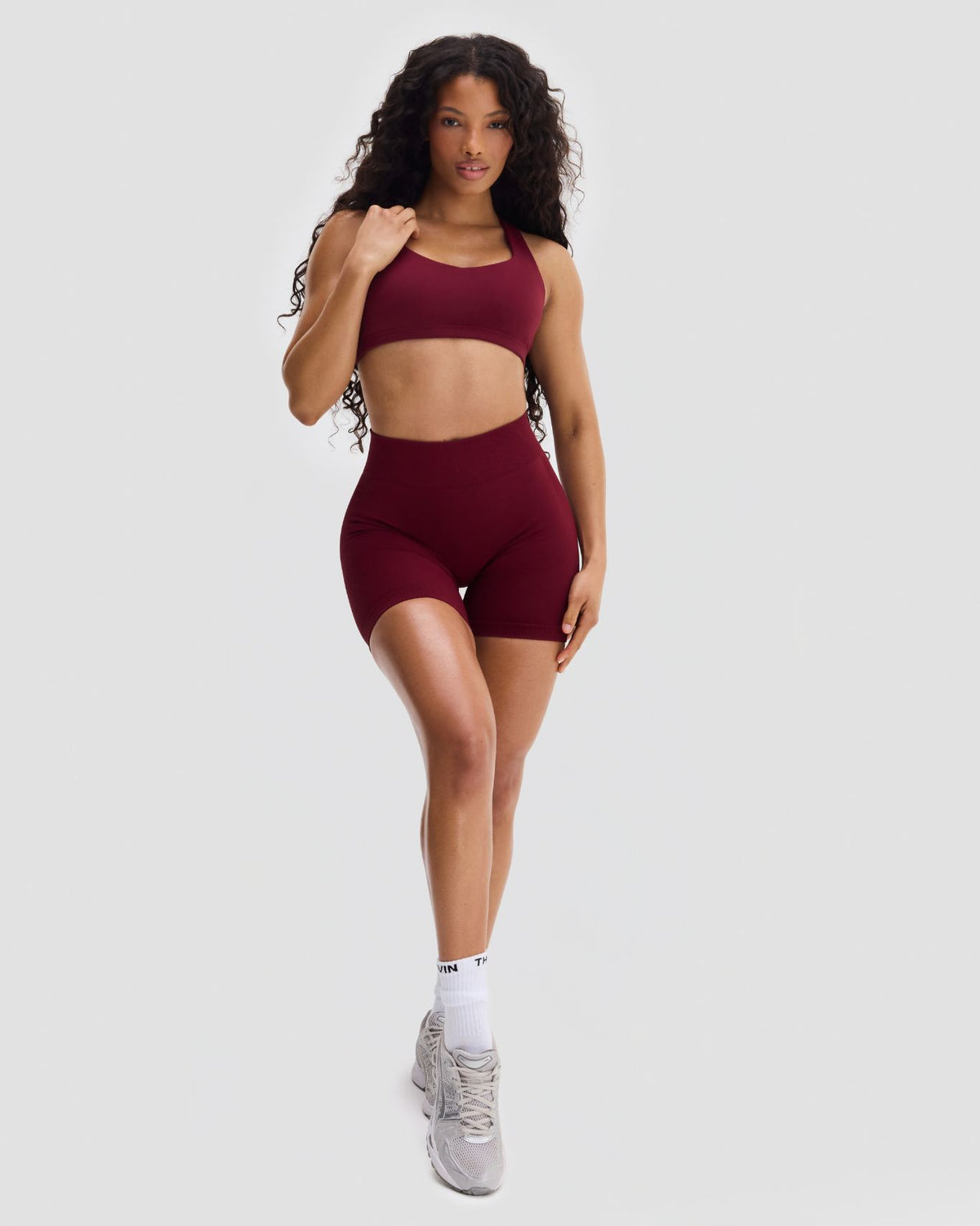 Elevate Sculpting Medium Impact Multiway Bra in Fine Wine Red, full-length front view of bra and matching shorts, walking