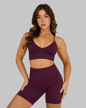 Elevate Multiway Sculpt Seamless Bra in Winter Plum Red, front view styled with shorts