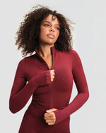 Elevate Compression Long Sleeve Jacket in Fine Wine Red, front view of full-length zip, stand collar and thumbholes