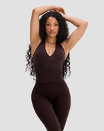 Elevate Sculpting Seamless Halterneck Top in Coffee Brown, front view with arms raised, styled with leggings