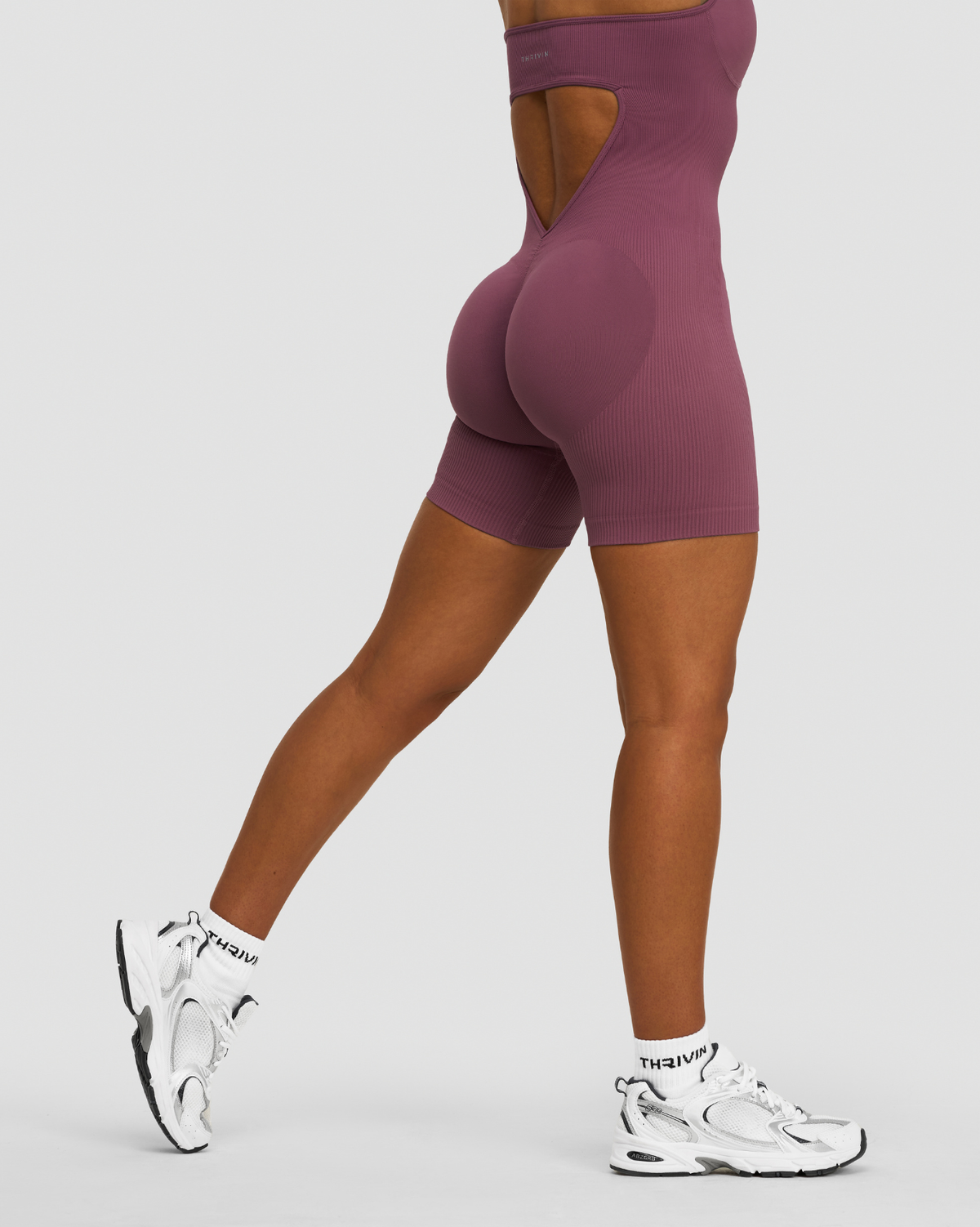 Elevate Sculpting Halterneck All In One in Orchid Mauve, back view with open back cutout, scrunch seam and ribbed knit