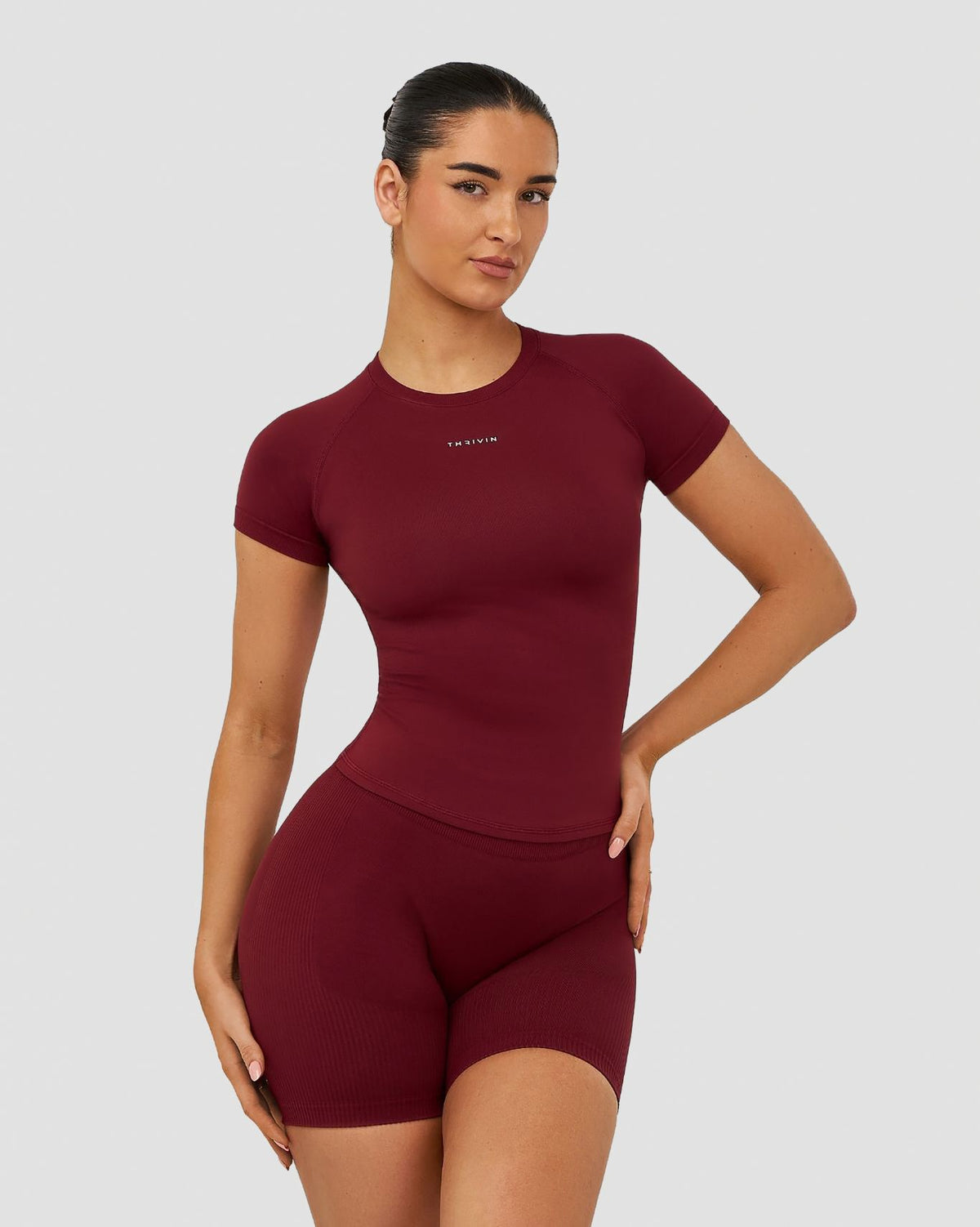Elevate Compression T-Shirt in Fine Wine Red, front view showing the slim compression fit and waist-length hem