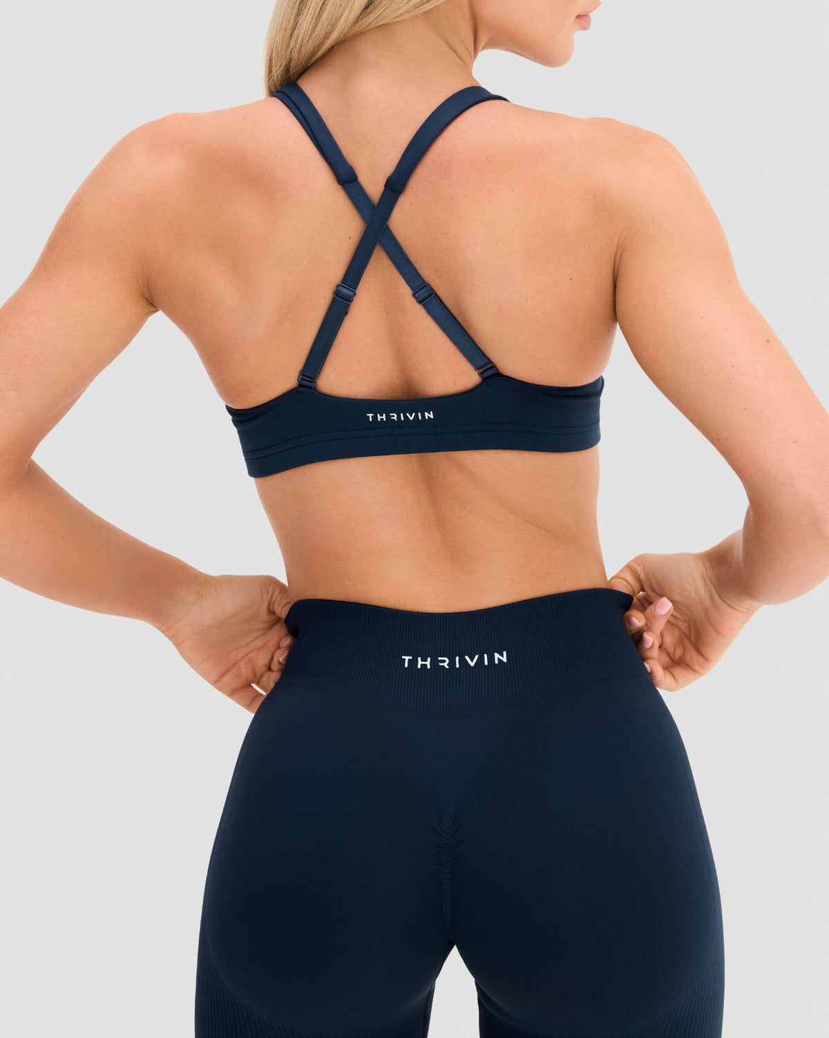 Elevate Sculpting Medium Impact Multiway Bra in Midnight Navy Blue, back view with crossed straps