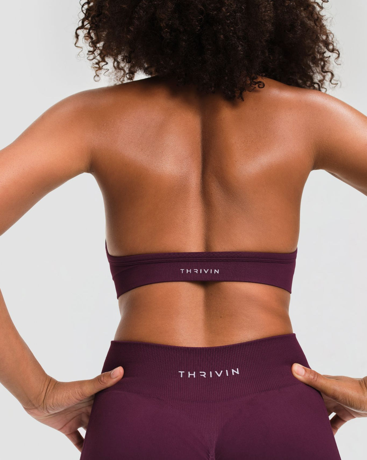 Elevate Sculpting Seamless Adjustable Halter Bra in Winter Plum Red, back view with open back and THRIVIN logo underband
