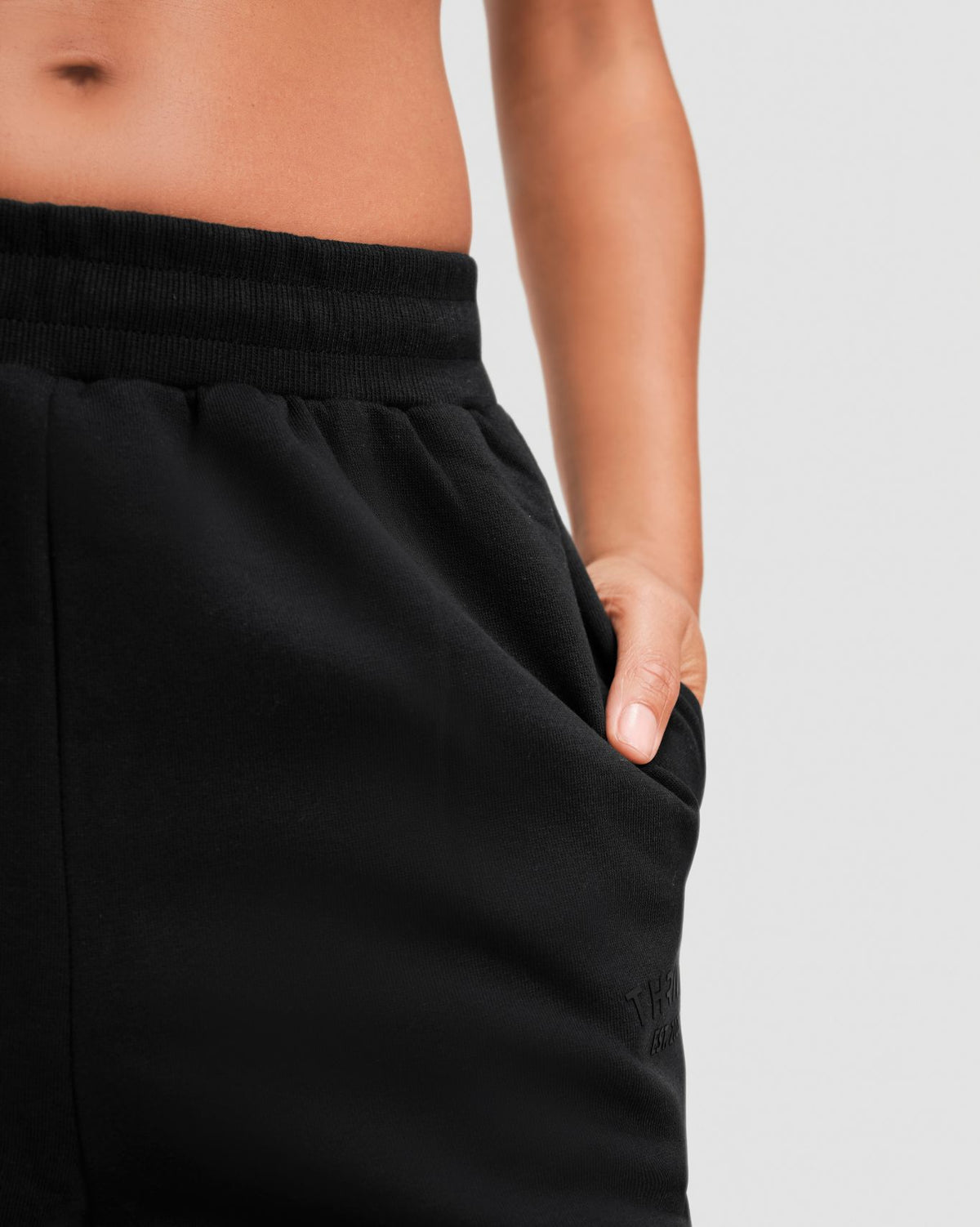 Original Straight Leg Jogger in Night Black, close-up of the ribbed elasticated waistband, side pocket and front leg seam