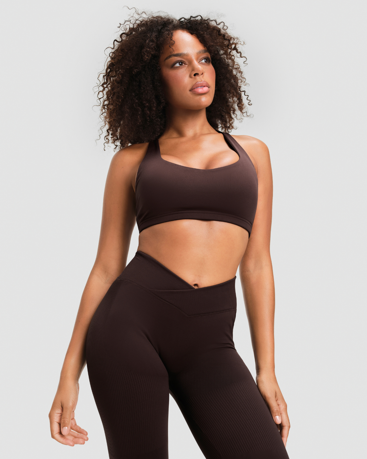 Elevate Sculpting Mid V-Waist Flare Leggings in Coffee Brown, close-up of the crossover V-waist sitting below the navel