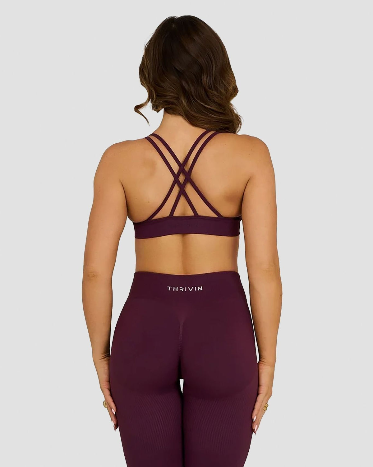 Elevate Sculpting Seamless High Apex Bra in Winter Plum Red, back view with crossover straps and Thrivin logo leggings