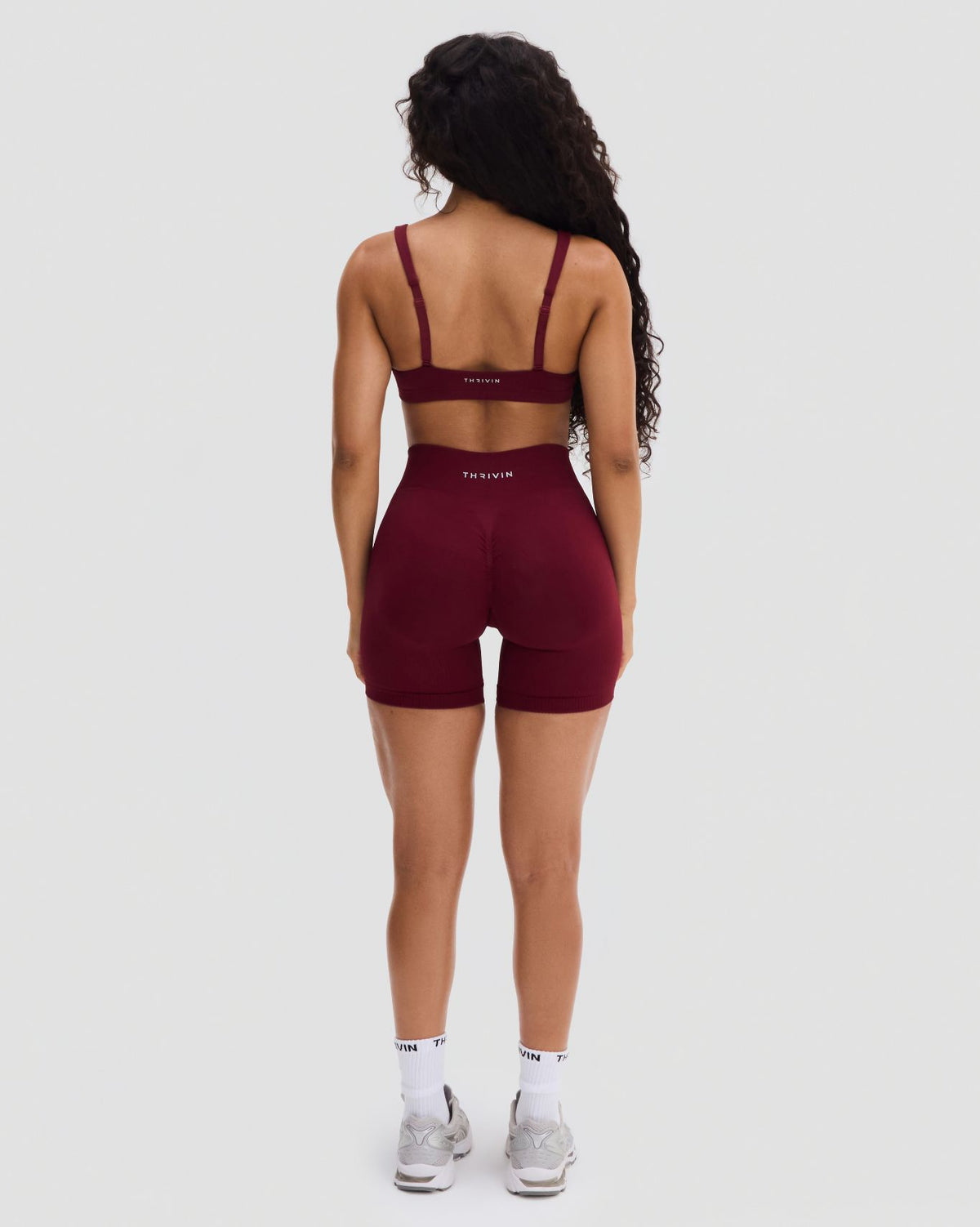 Elevate Sculpting Medium Impact Multiway Bra in Fine Wine Red, full-length back view with matching shorts