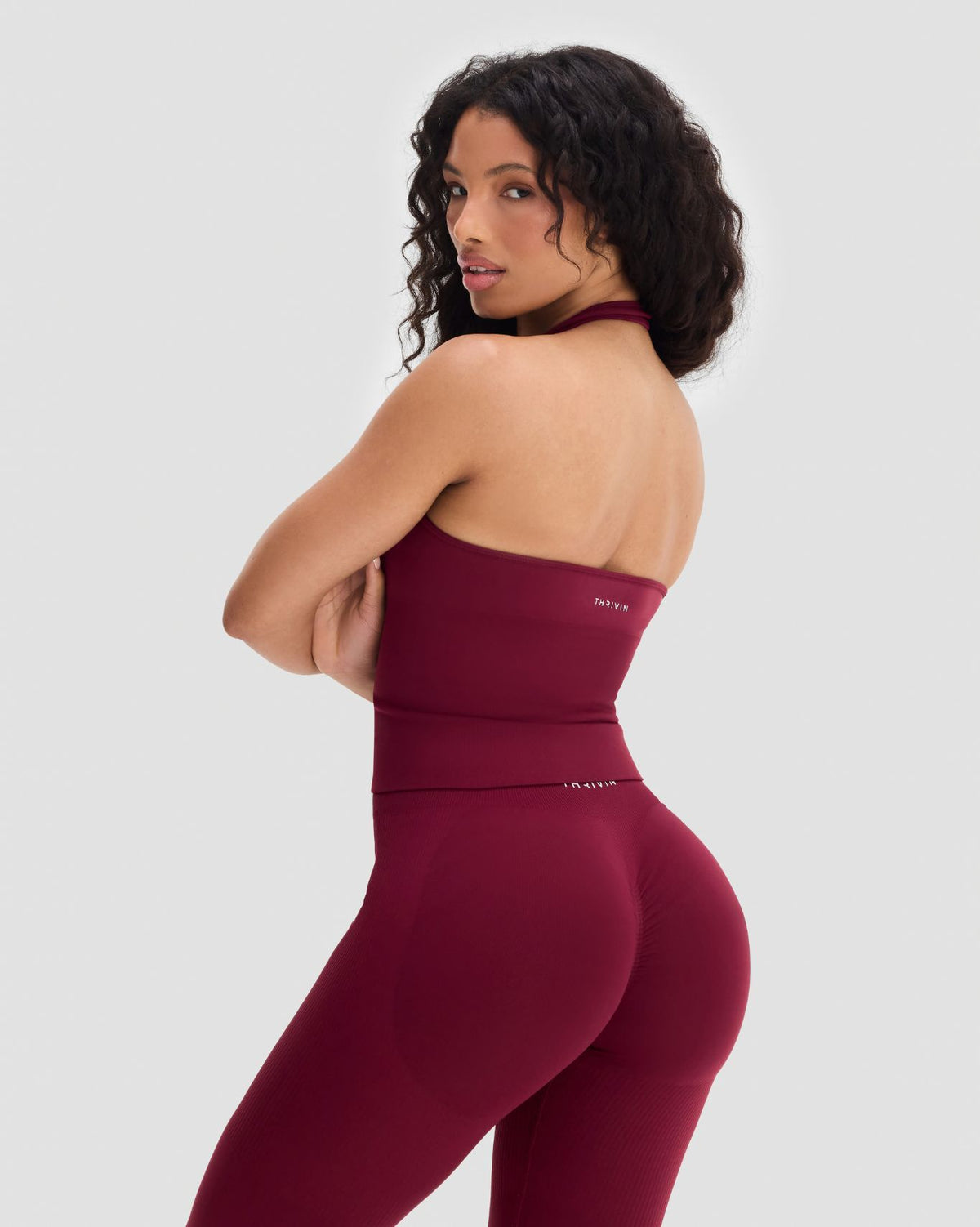Elevate Sculpting Seamless Halterneck Top in Fine Wine Red, back view with open halter back, styled with leggings