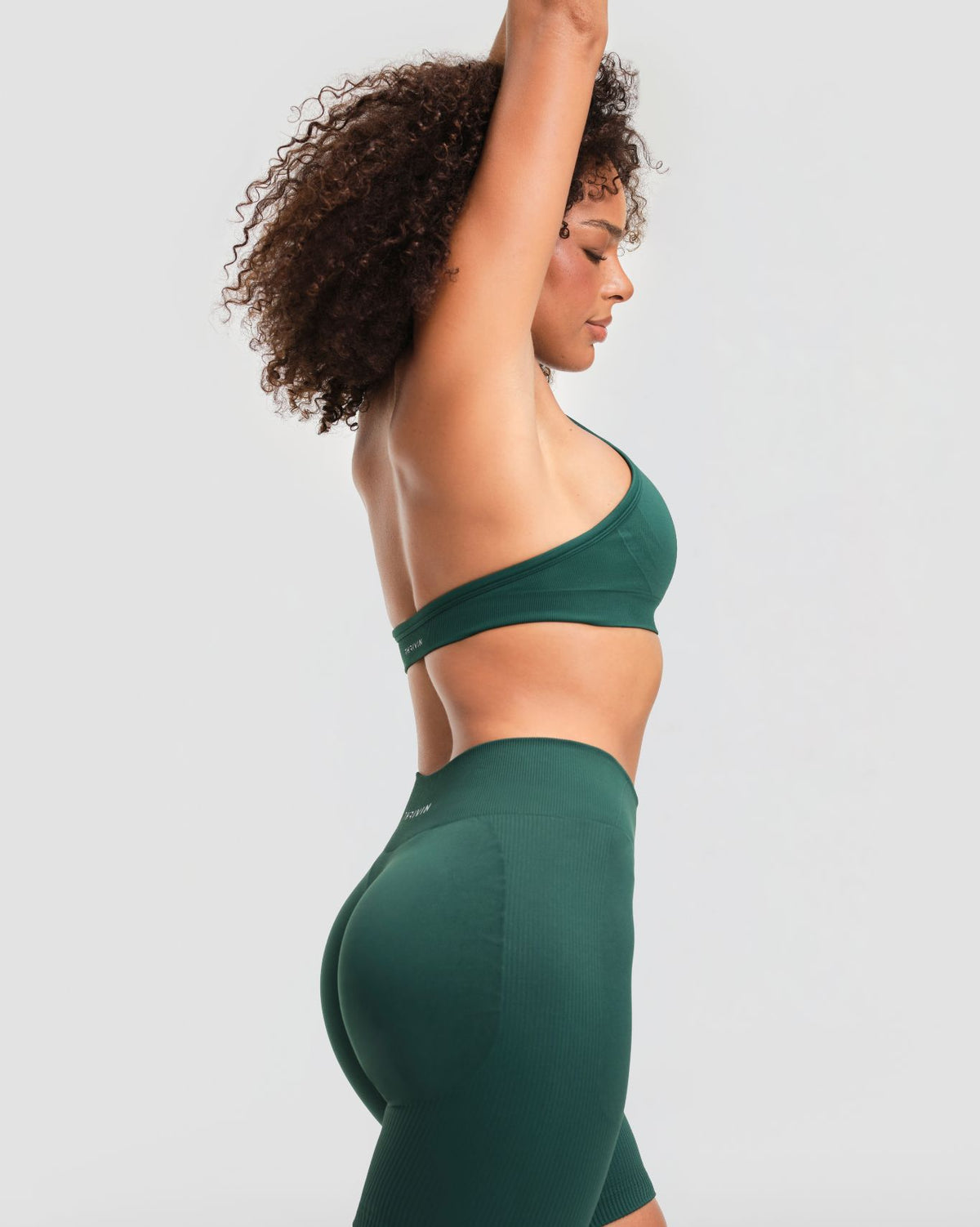 Elevate Sculpting Seamless Adjustable Halter Bra in Pine Green, three-quarter back view of open back and underband