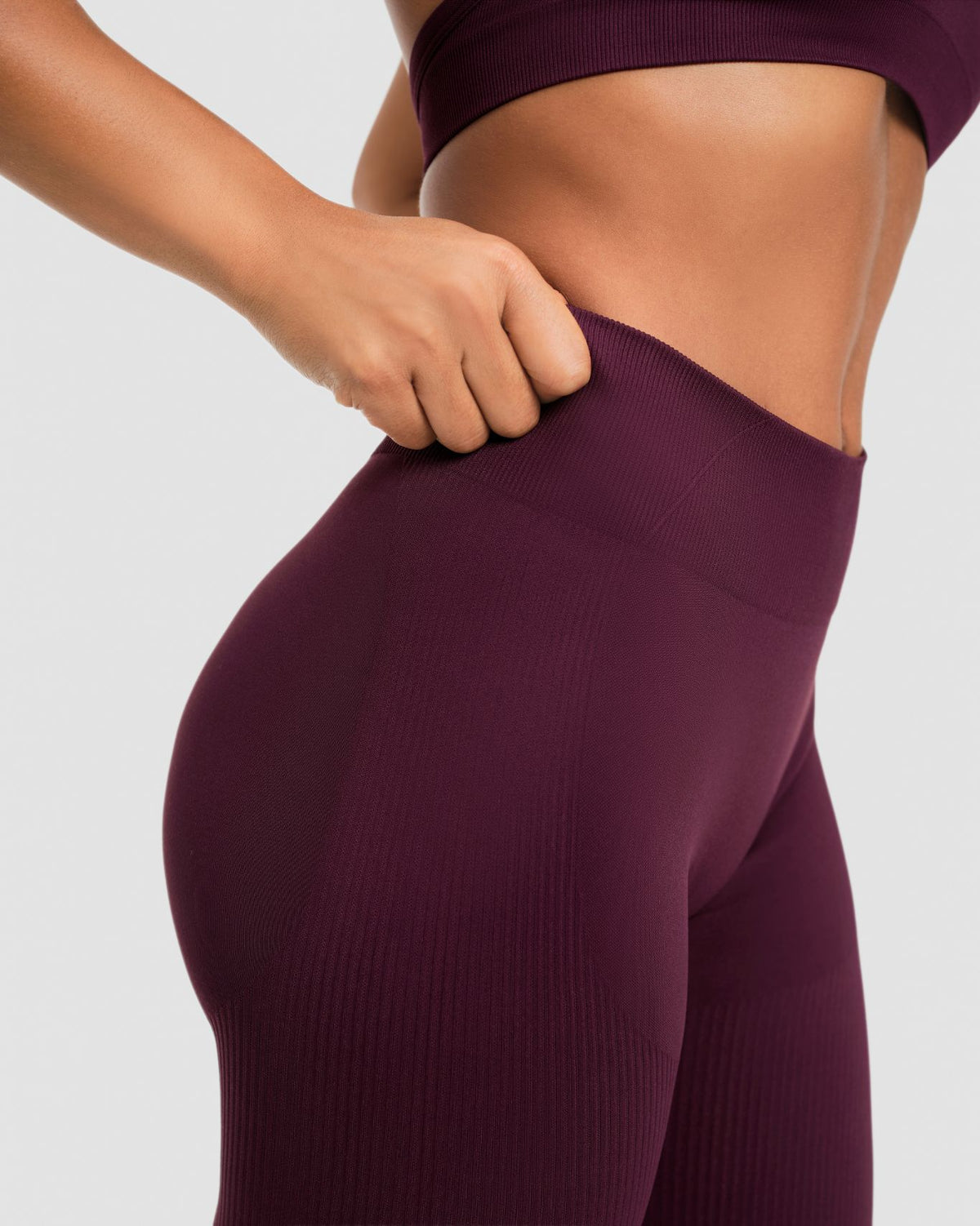 Elevate Sculpting Mid Waist Scrunch Leggings in Winter Plum Red, side close-up of waistband stretch and ribbed fabric