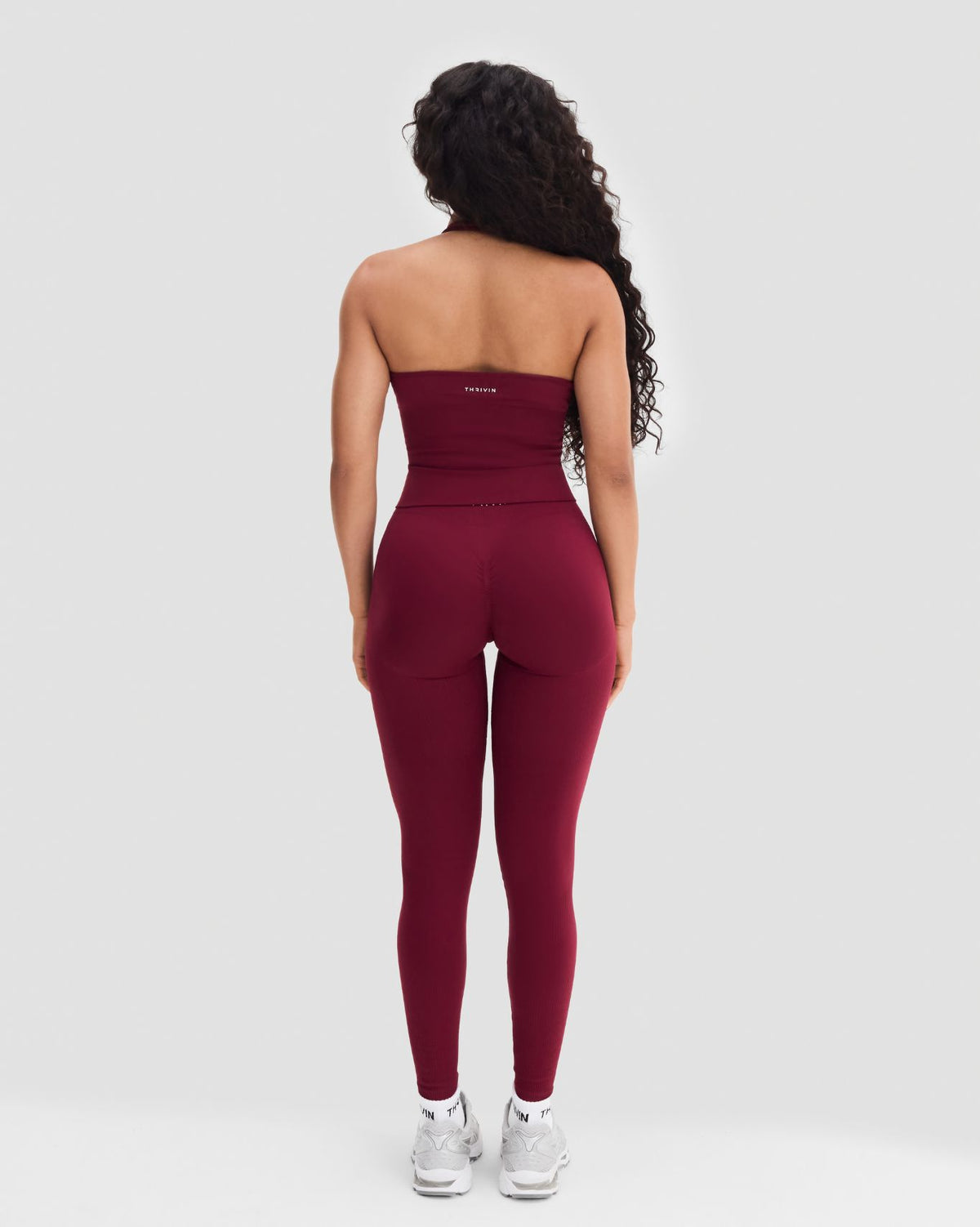 Elevate Sculpting Seamless Halterneck Top in Fine Wine Red, full-length back view with leggings and sneakers