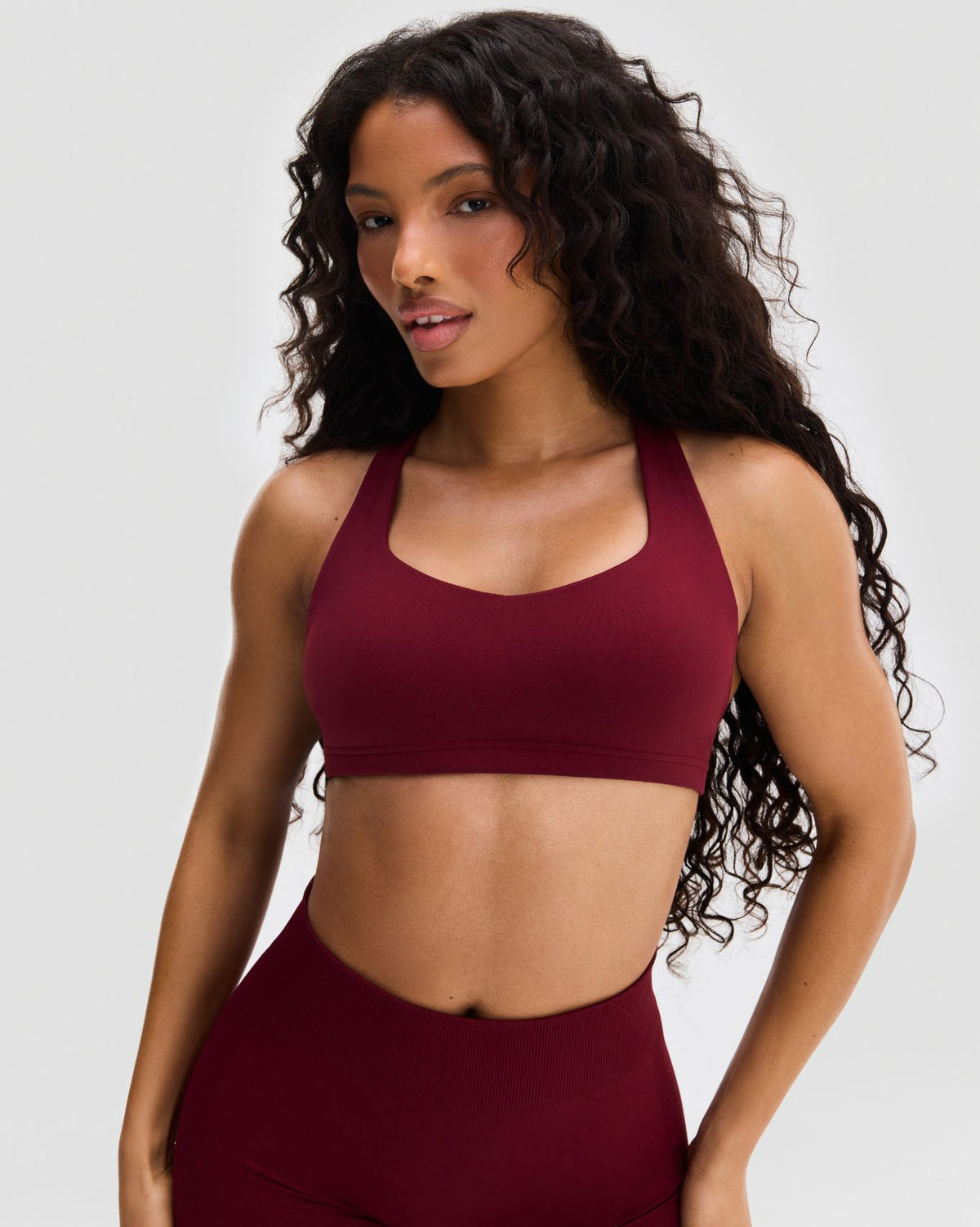 Elevate Sculpting Medium Impact Multiway Bra in Fine Wine Red, front view of scoop-neck bra with matching shorts