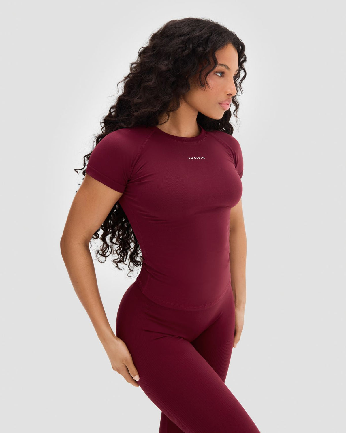 Elevate Compression T-Shirt in Fine Wine Red, three-quarter front view with matching leggings