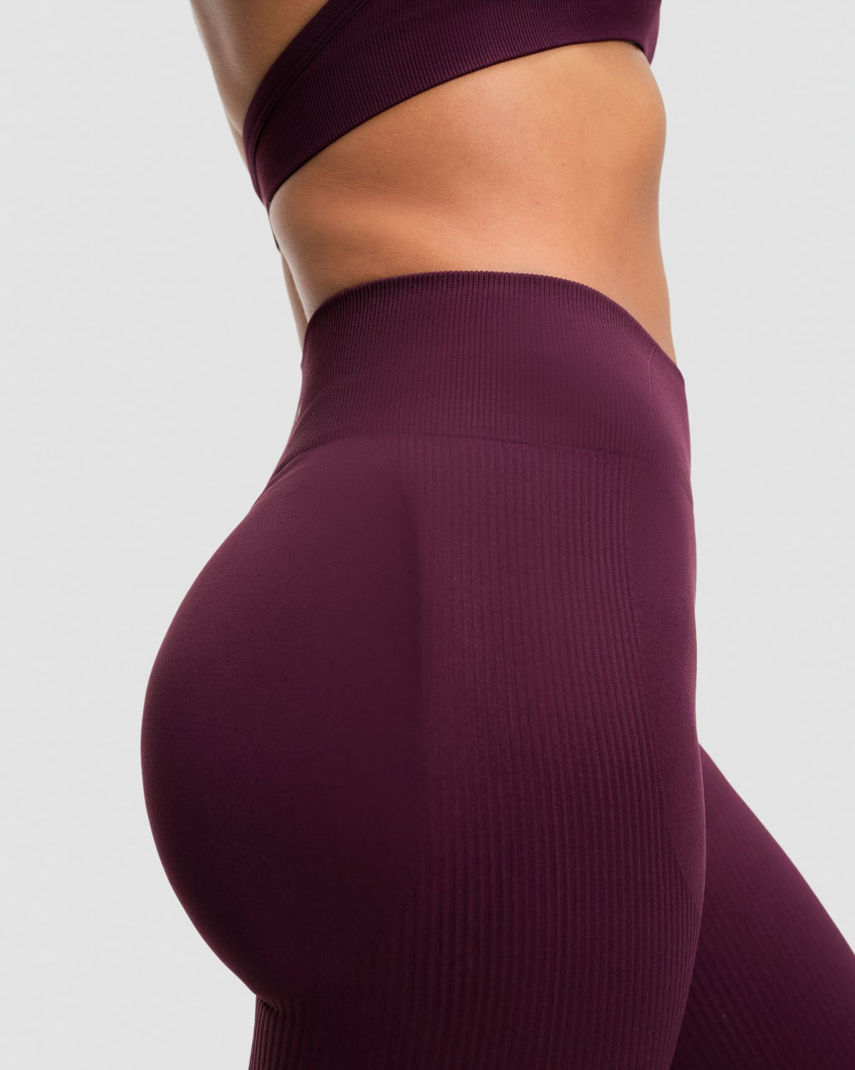 Elevate Sculpting Mid Waist Scrunch Leggings in Winter Plum Red, side close-up of ribbed contour knit and sculpting fit