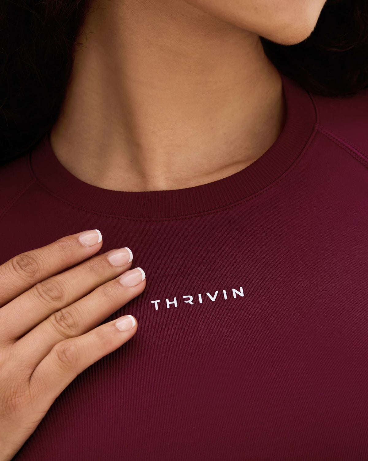 Elevate Compression T-Shirt in Fine Wine Red, front neckline close-up of THRIVIN logo