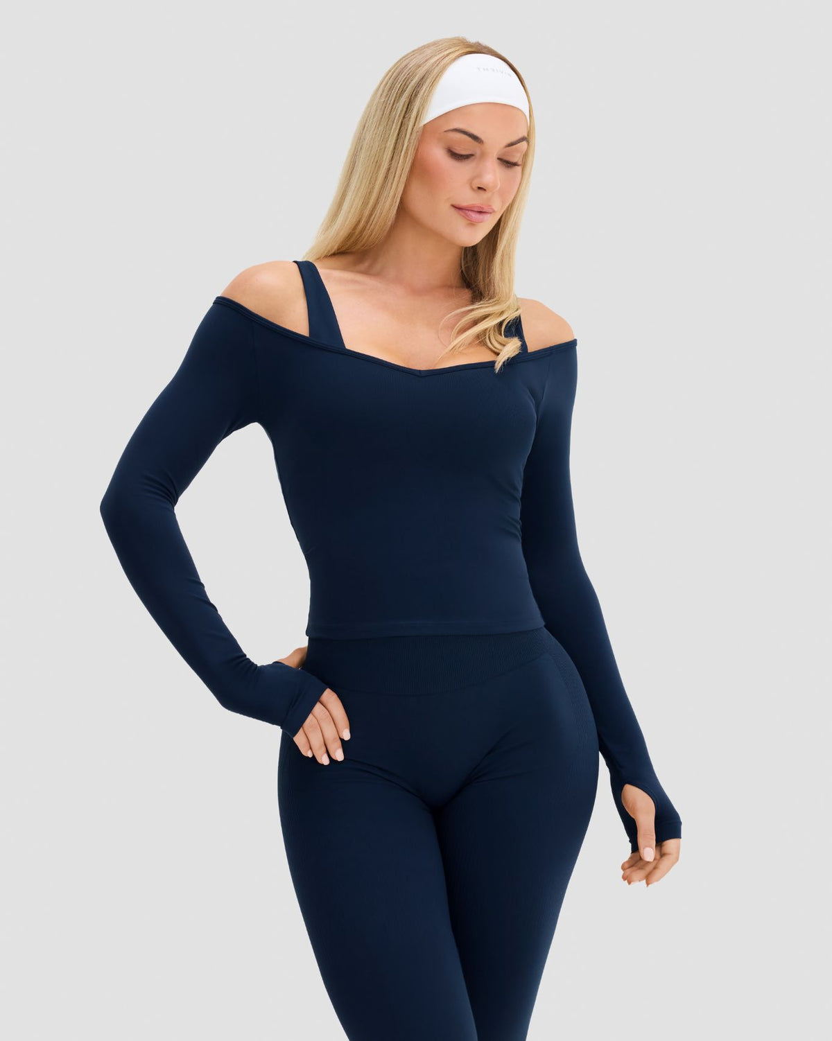 Elevate Sculpting Seamless V-Neck Top in Midnight Navy Blue, front view with long sleeves and cold shoulder detail
