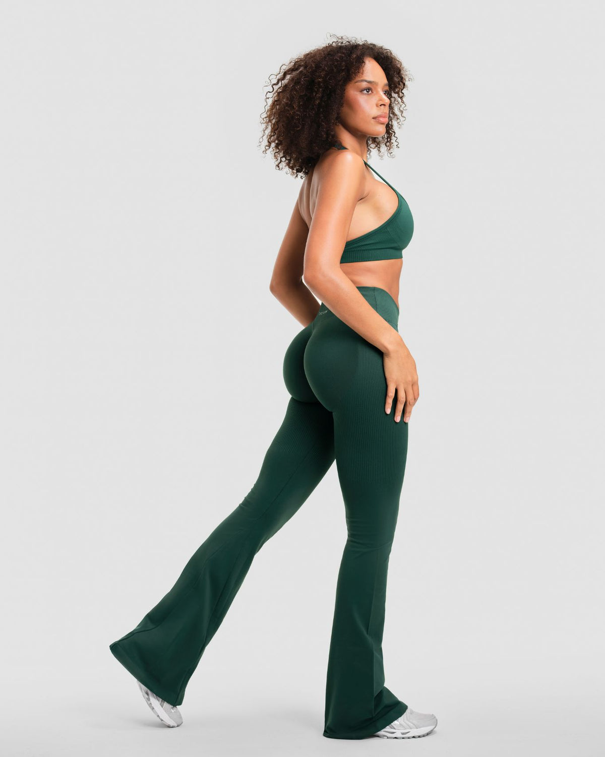 Elevate Sculpting Mid V-Waist Flare Leggings in Pine Green, full-length three-quarter back view with flared hem