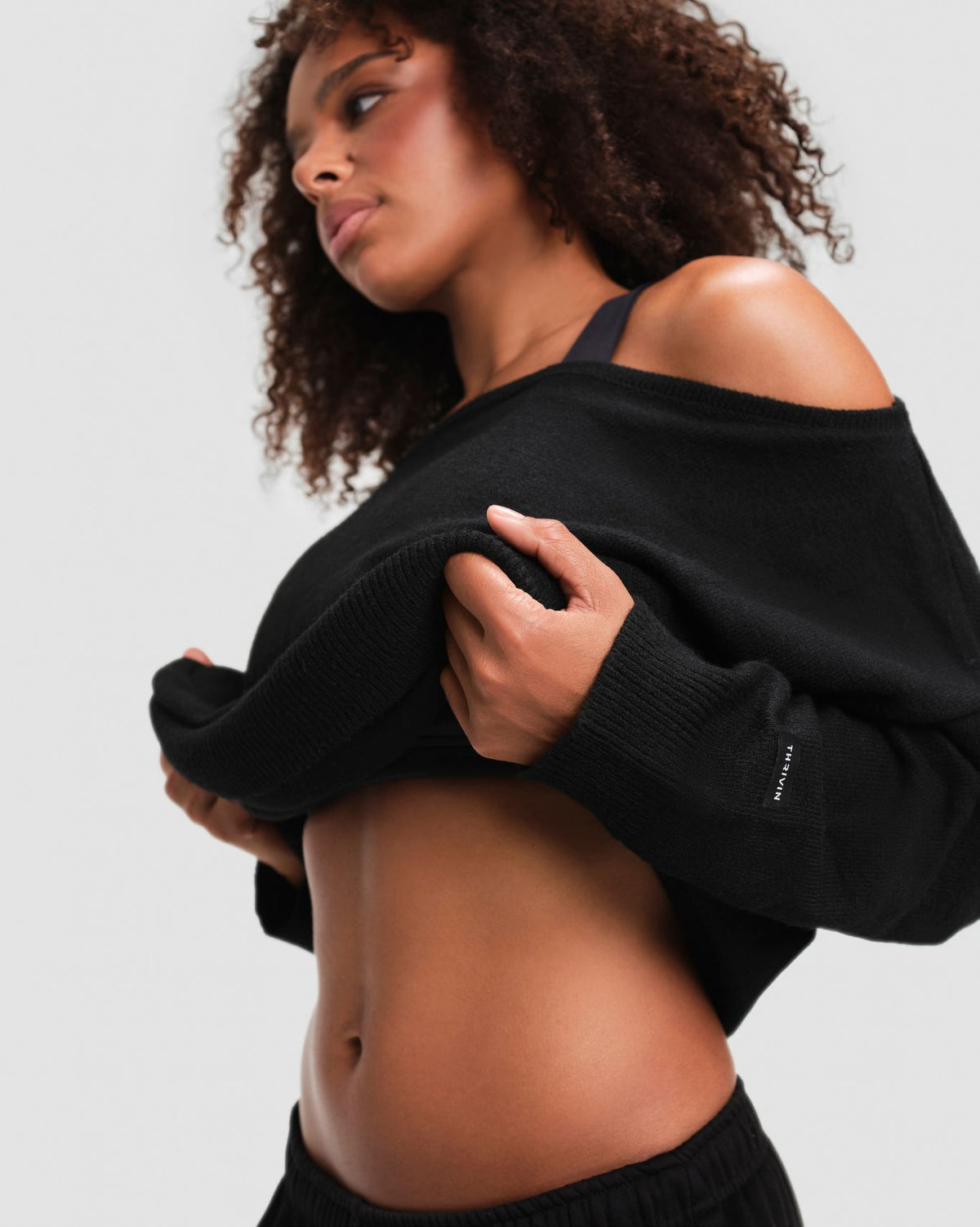 The Essential Collection Off The Shoulder Wool Blend Sweater in Night Black, close-up of ribbed cuff and cropped hem