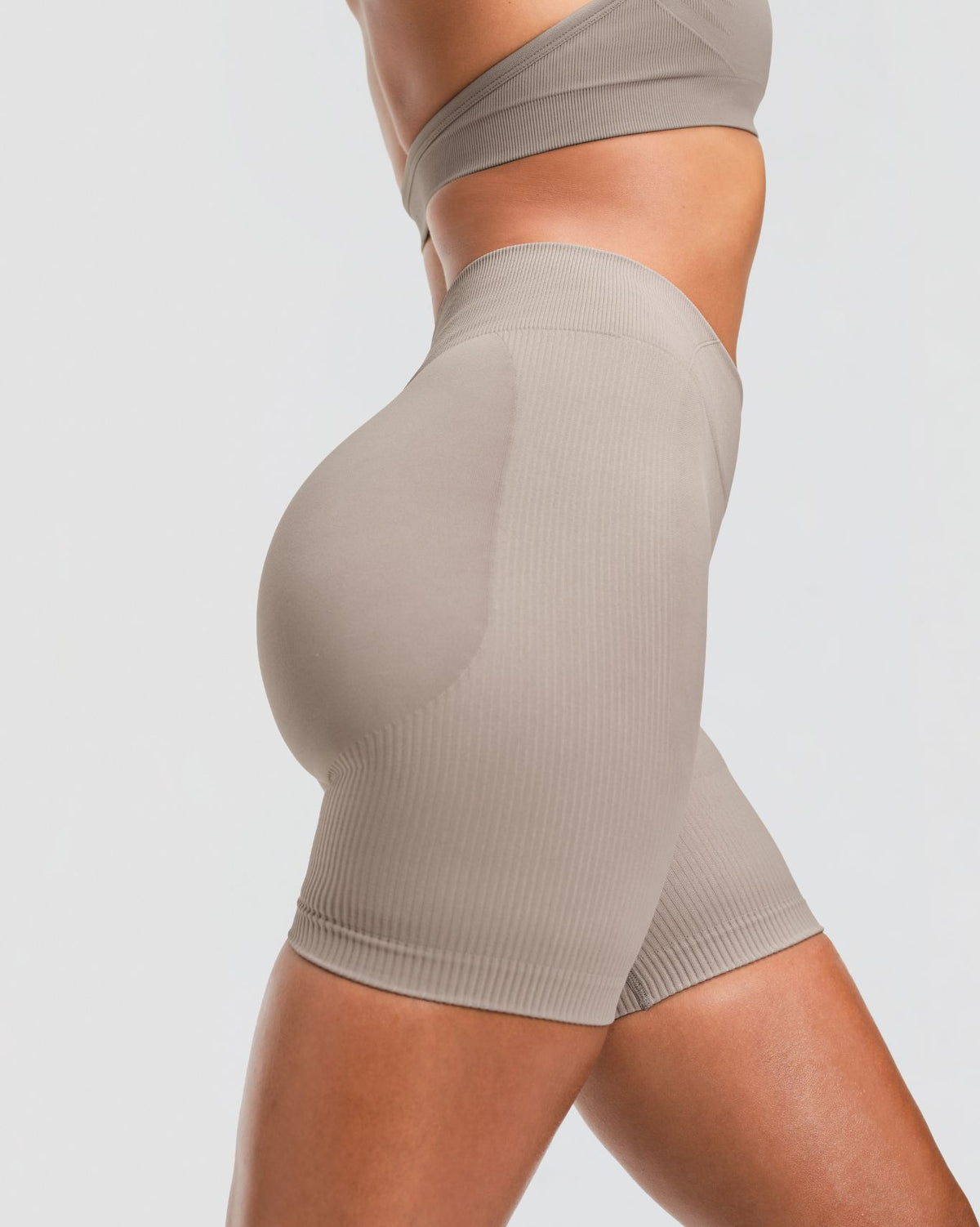Elevate Sculpting Mid Waist Scrunch Shorts in Latte Grey, side close-up of sculpted seat and leg hem in ribbed sculpting knit