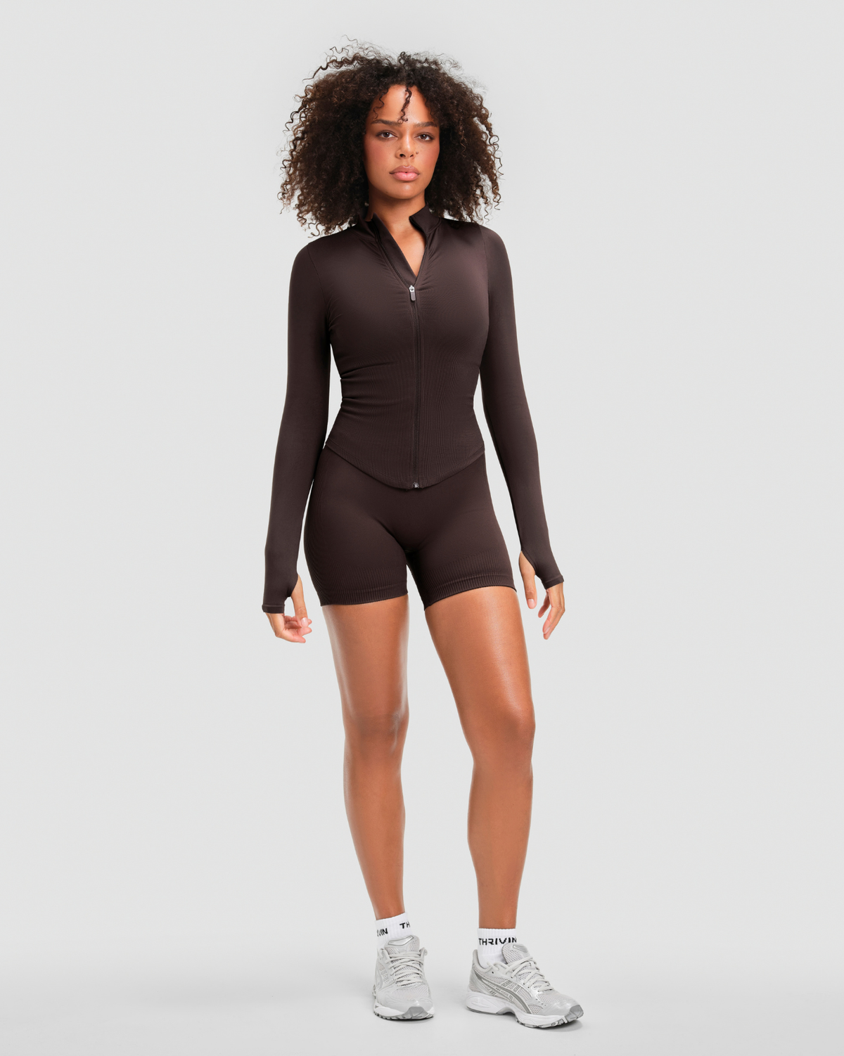 Elevate Compression Long Sleeve Jacket in Coffee Brown, full-length front view zipped, styled with matching shorts