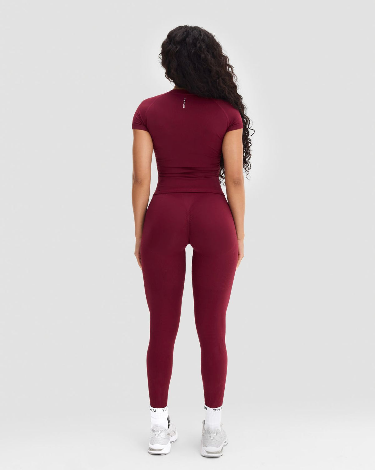 Elevate Compression T-Shirt in Fine Wine Red, full-length back view with matching leggings