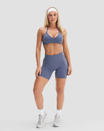 Elevate Sculpting Mid Waist Scrunch Shorts in Steel Blue, full-length front view with matching sports bra