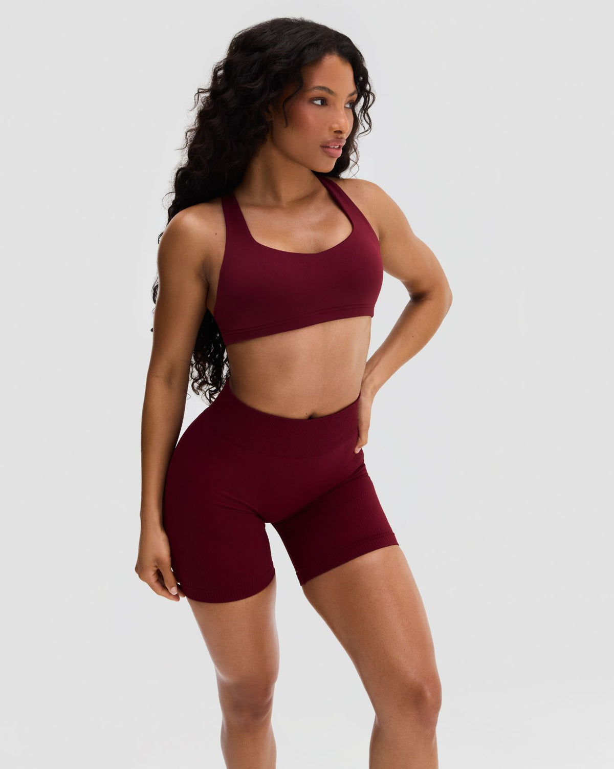 Elevate Sculpting Medium Impact Multiway Bra in Fine Wine Red, three-quarter view of scoop neckline, matching shorts