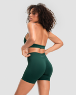 Elevate Sculpting Mid Waist Scrunch Shorter Shorts in Pine Green, three-quarter back view with Thrivin logo waistband